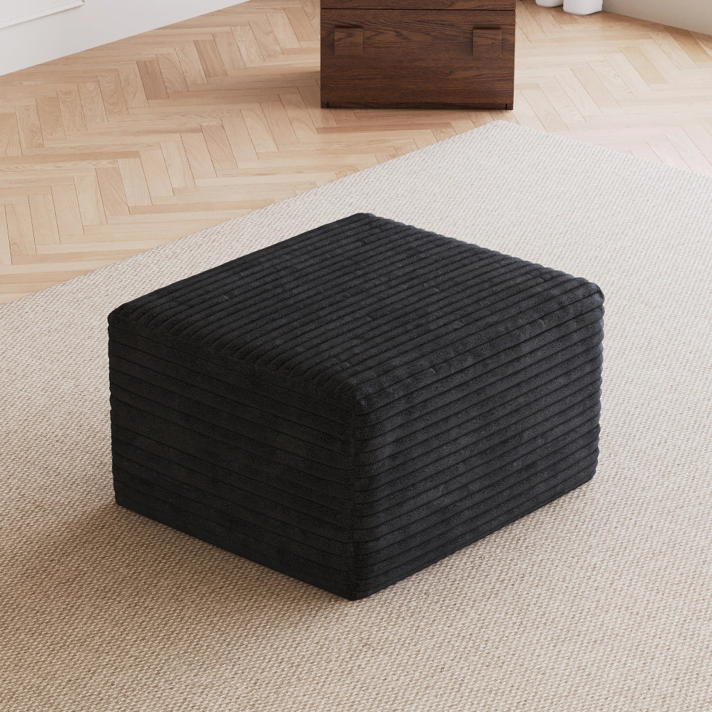 Pouf in tessuto nero senza montaggio