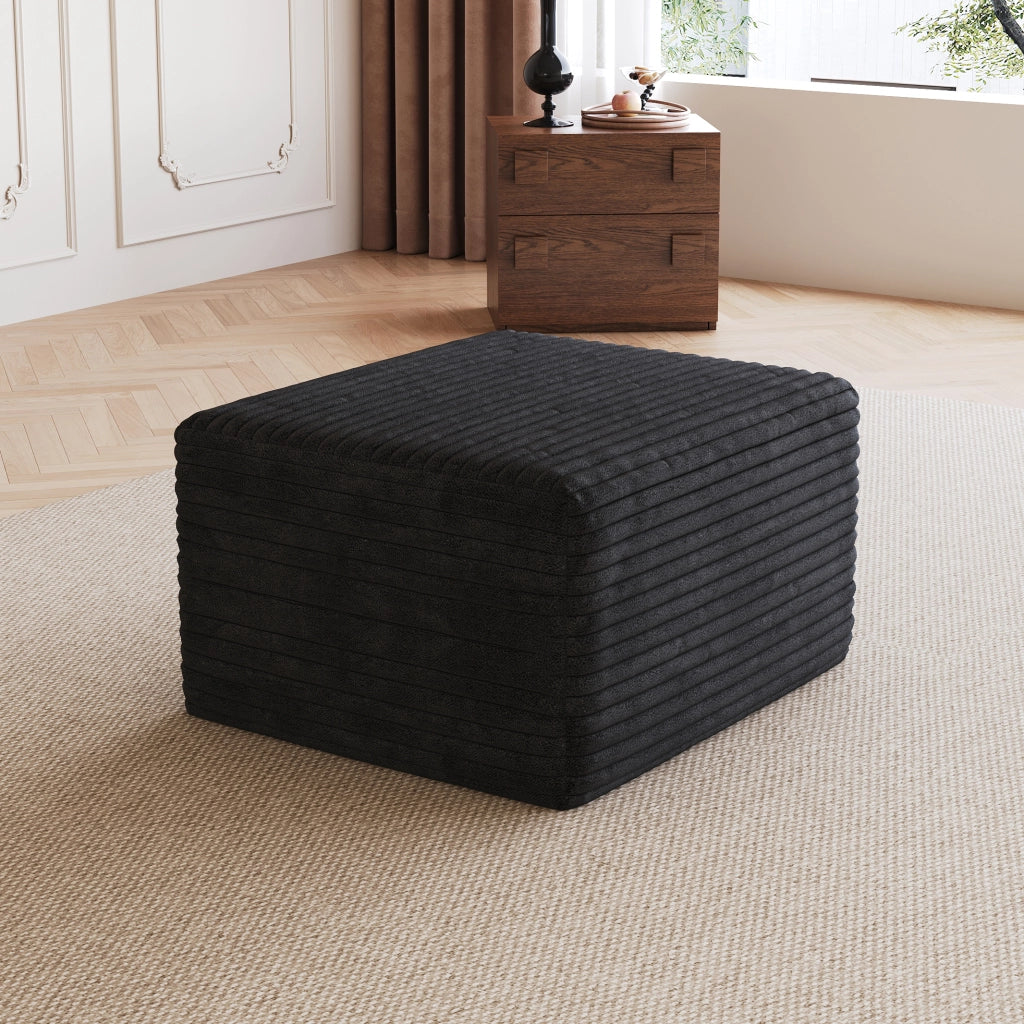 Pouf in tessuto nero senza montaggio