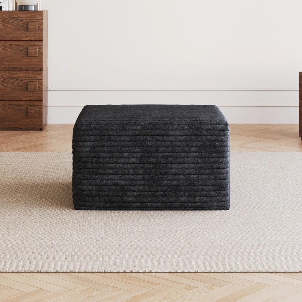 Pouf in tessuto nero senza montaggio